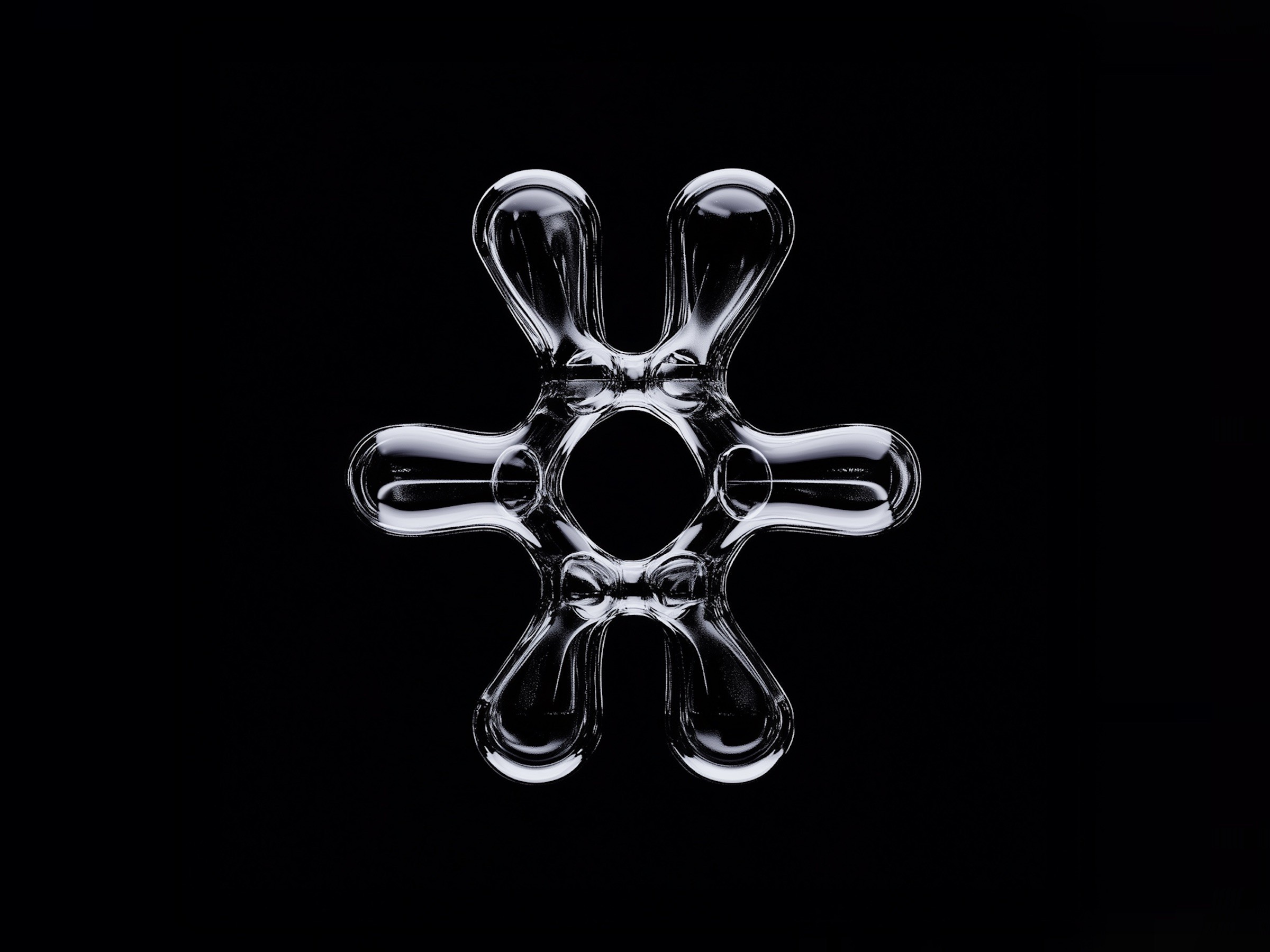 A glossy liquid-metal shape on a black background.
