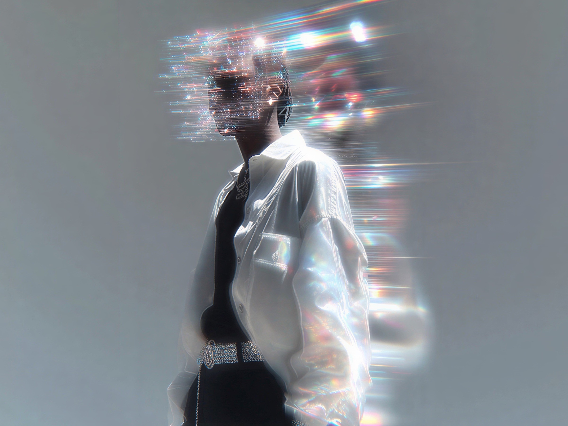 A man in a white shirt blurring into streaks of light as he walks.